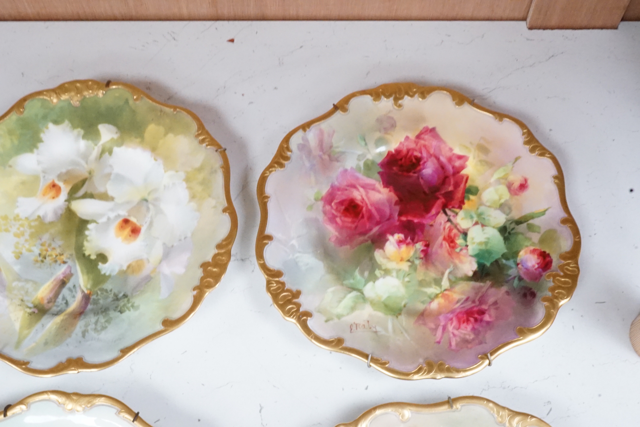 Six Royal Doulton floral painted plates, three signed E. Raby and three signed D. Dewsberry